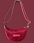Red textured handbag with 'BELEGRA' logo on a dark red background