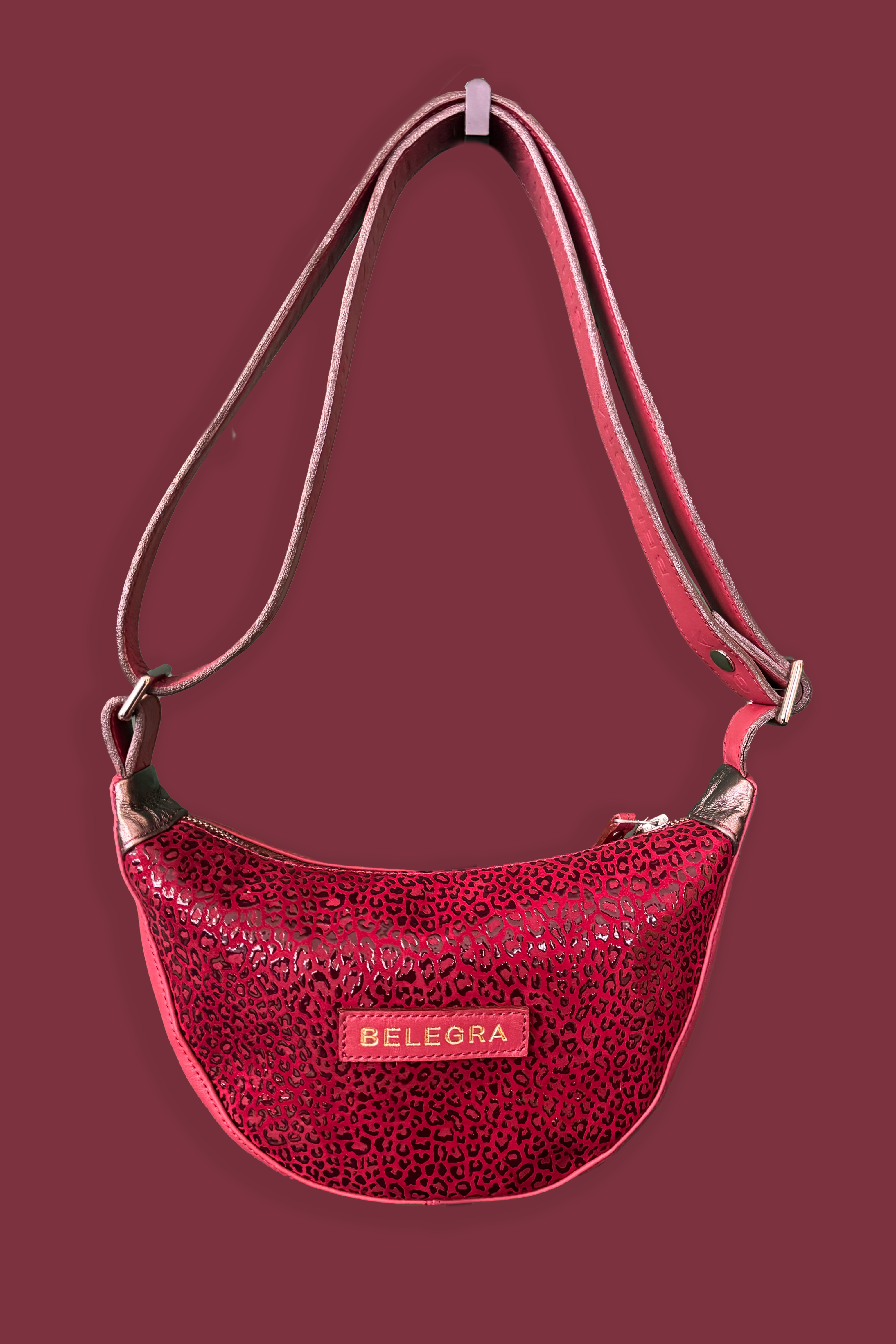 Red textured handbag with 'BELEGRA' logo on a dark red background